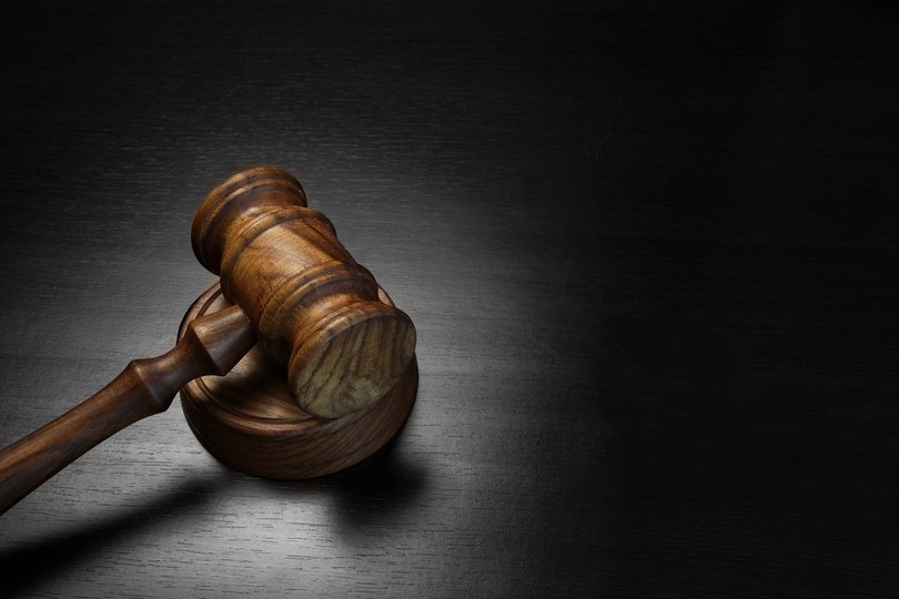 Light Wooden Gavel on Dark Surface