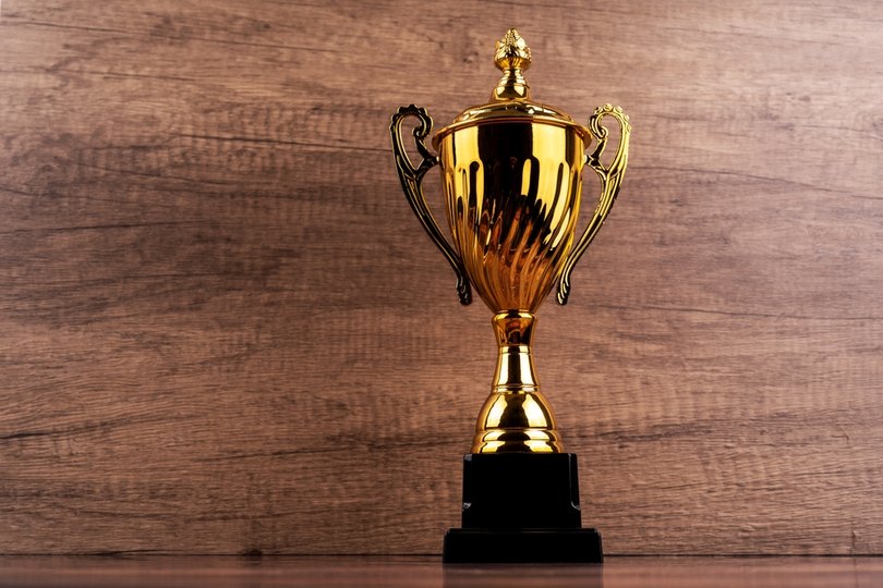 Gold Trophy Against Wooden Background
