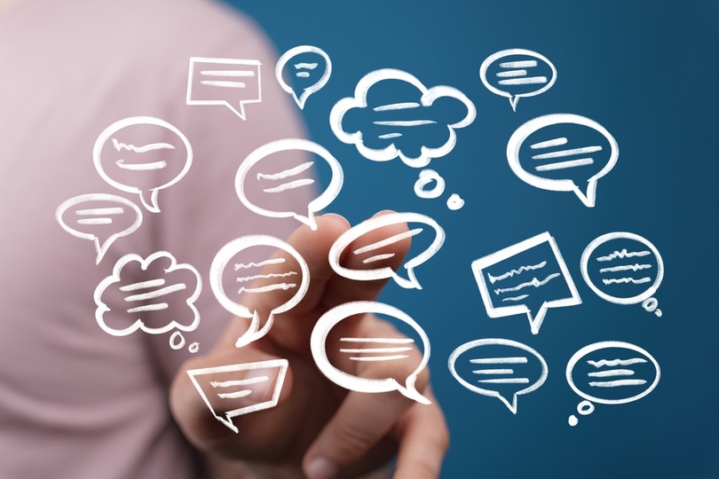 Person Pointing at Speech Bubbles