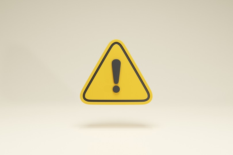 Yellow 3D Warning Triangle Against Light Background